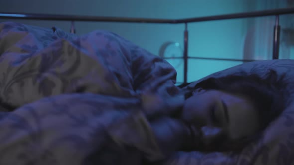 Girl have difficulty falling asleep A Young Woman Lies in Bed at Night and Cannot Sleep alt