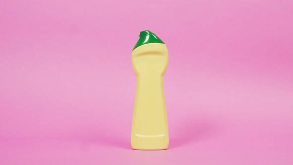 Yellow Plastic Bottle with Household Chemicals with a Green Lid