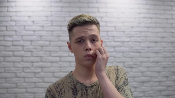 Close Up Sad Teenage Guy with Acne and Problem Skin