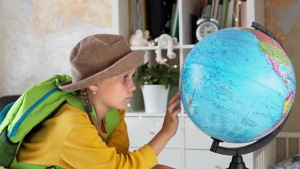Child Traveler with a Globe