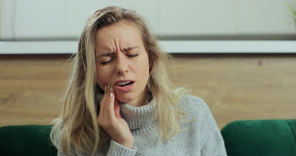 Woman Feeling Strong Pain in Tooth While Staying at Home alt