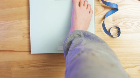 Young Woman with White Pedicure Steps on Electronic Scales Slow Motion