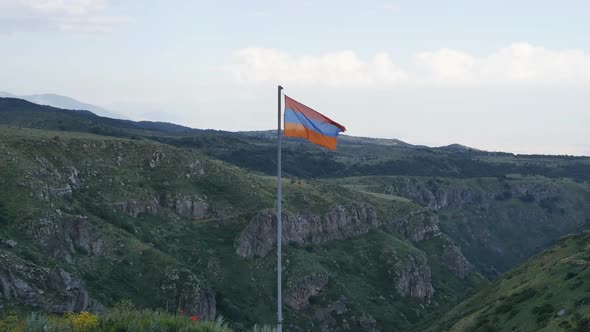 the Flag of the Republic of Armenia is Set in the Mountains Swaying in the Wind Against the Backdrop alt