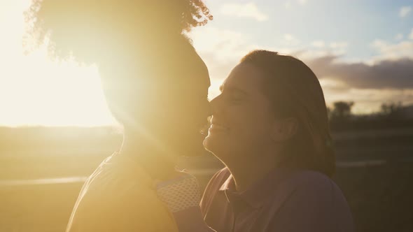 Happy women gay couple having tender moments during sunset outdoor alt