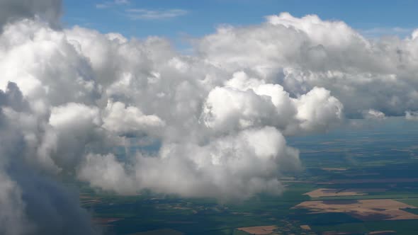 Flying in a Plane Through the Fluffy, Snow-white Clouds. Spectacular View From the Window of an