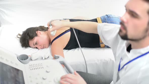 Woman Being Checked at Ultrasound Device alt