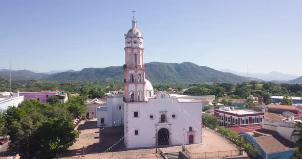 Picturesque view of historic church and sunny rural landscape. Cosala, Mexico alt