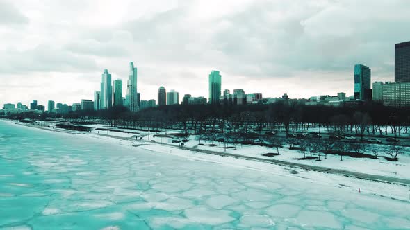 cars driving next to lake michigan at sunset in winter alt