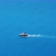 Small Boat Quickly Floating on the Calm Water Surface and Leaving a Trail on the Sea.  Video - VideoHive Item for Sale