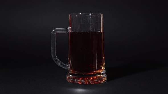 Beer is poured into stop motion into the glass alt