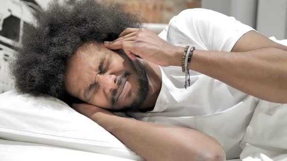 Headache Sleeping African Man with Head Pain alt