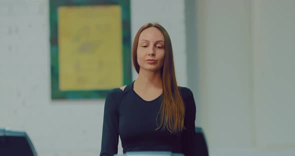 Young Beautiful Girl Steps on a Running Simulator alt