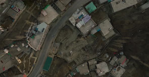 Village Green gardens in mountain valley Pakistan aerial view. Overview of houses from baltit fort, alt