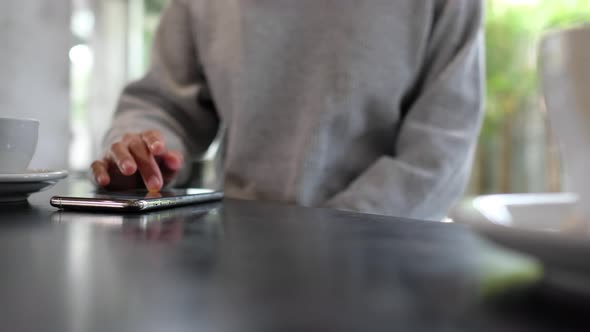 Closeup of a woman touching and scrolling on smart phone screen