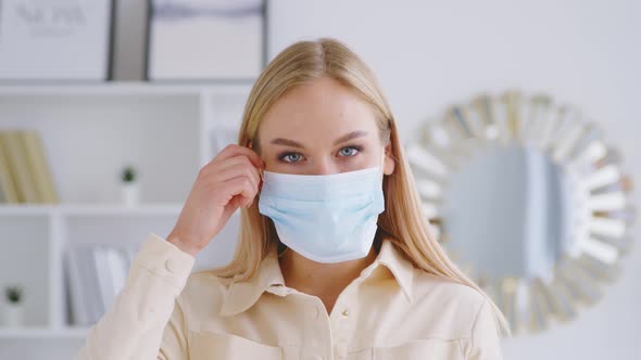 Young smiling girl taking off his mask indoors alt