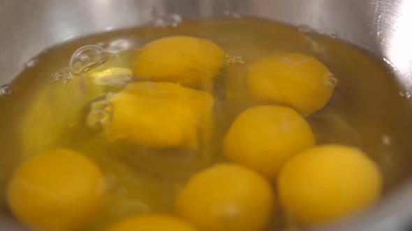 The Yolk and Protein Slowly Fall Into the Bowl