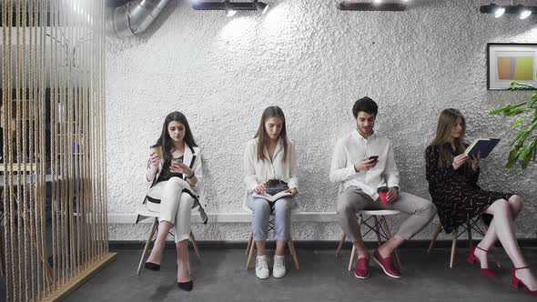 Diverse Applicants Waiting for Their Turn Sit in Line alt