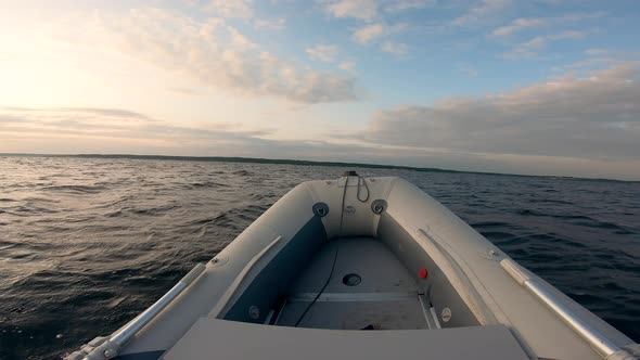Rubber Boat's Bow While Drifting in the Sunset Waters alt
