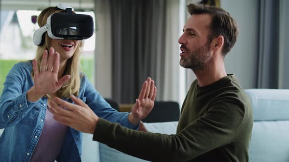 Modern couple using virtual reality simulator alt