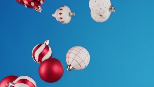 Flying Christmas Balls Against Blue Background