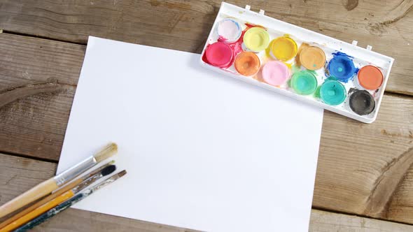 Watercolor paint and paintbrushes with canvas alt