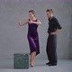 Man Teaching Woman Dancing Tango in Grey Studio Against Large Windows - VideoHive Item for Sale