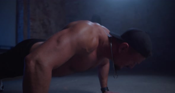 Man Athlete Doing Push Ups in a Urban Gym
