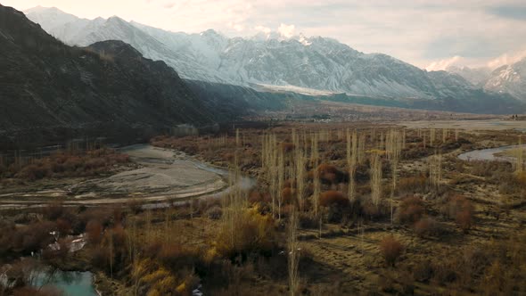 Aerial Flying Over Sweeping Landscape Of Ghizer Valley Of Gilgit Baltistan With Snow Capped Mountain alt