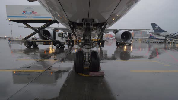 Aircraft of Korean Air with boarding bridge and container loader alt