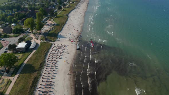 Aerial Drone View of Two Sailboats in Tourist Beach at Baltic Sea Coastline Scharbeutz Germany alt
