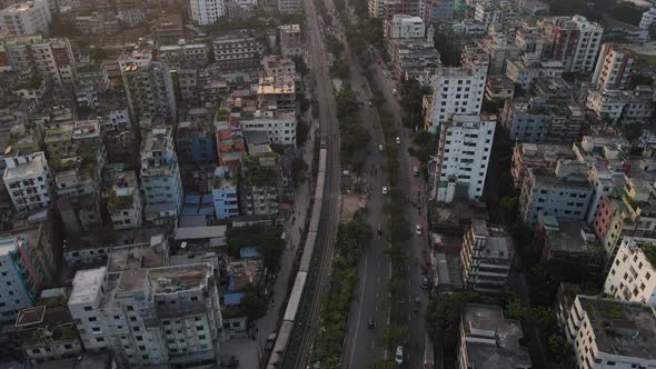 Train going through city. Aerial top down drone shot 4k alt