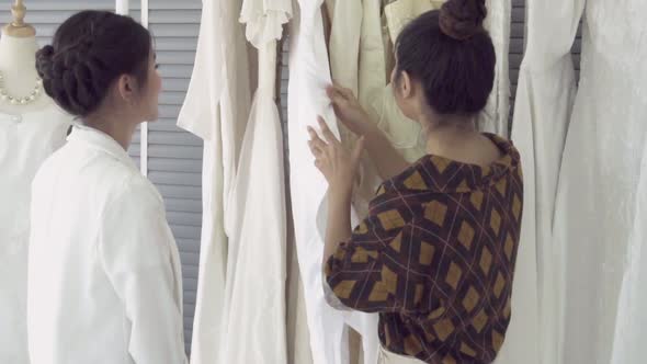 Future Bride Customer Talking with Wedding Store Shopkeeper alt