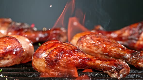 Super Slow Motion Shot of Seasoning Falling on Fresh Grilled Chicken Legs at 1000 Fps alt