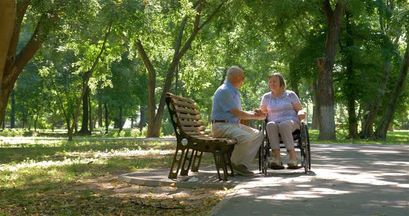 Senior Man Spending Time with Wife in Wheelchair