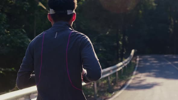 Healthy teenage boys running on the street for exercise. Young male athlete jogging outdoors.