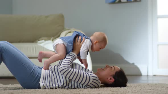 Mother Lying and Playing with Baby alt