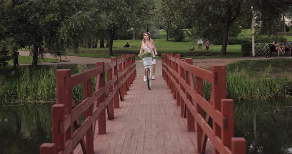 Lovely Woman with Kanekalons Riding a Bicycle