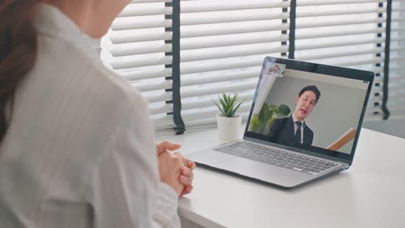 Close up of Asian woman use laptop for virtual online video call with hr manager for job interview. alt