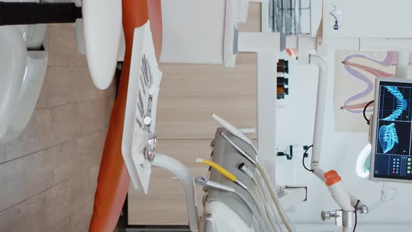 Vertical Video Interior of Modern Equipped Dental Office with x Ray on Monitors alt