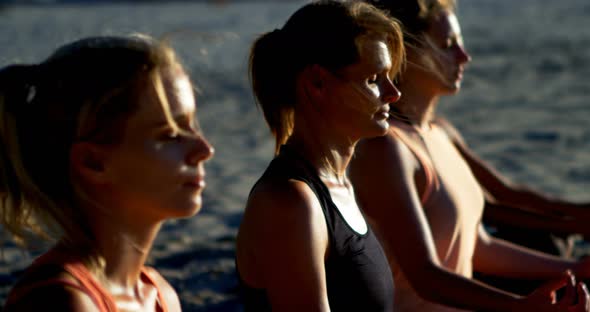 Female Volleyball Players Performing Yoga in The Beach 4k alt