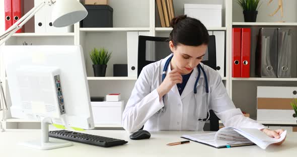 Medical Worker Examining Medical Card in Office