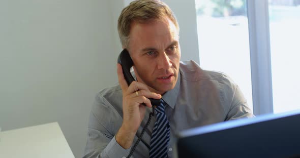 Businessman talking on telephone in office 4k