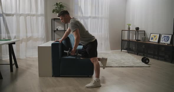Jock Is Training at Home Lifting Dumbbell By One Hand Workout for Biceps and Triceps Healthy alt