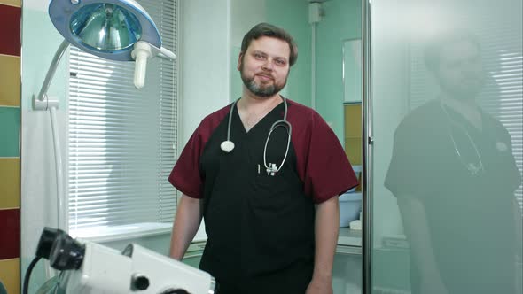 Positive doctor man looking at camera smiling