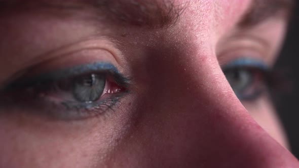 Reflection of screen on person's blue green eye in dark room 20