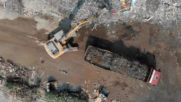 Aerial Overhead View of a Demolition Site with One Excavator and a Truck