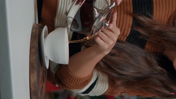 Vertical Video Close Up of Woman with Kettle Pouring Tea in Cup at Home alt