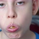 portrait caucasian boy 7-8 years old eats sushi with chopsticks and looks at the camera. child eats - VideoHive Item for Sale