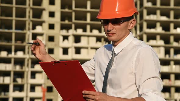 Builder In Hardhat With Red Clipboard