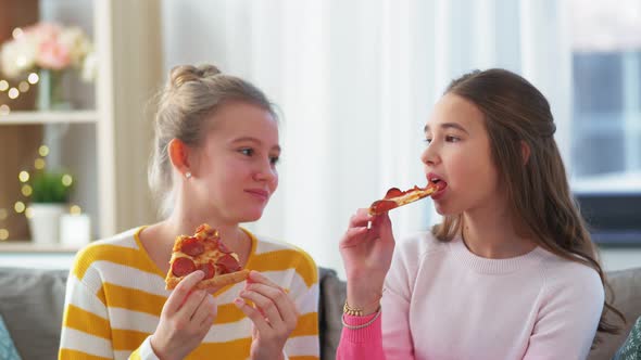 Happy Teenage Girls Eating Takeaway Pizza at Home alt